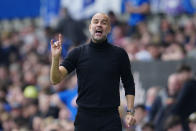 Manchester City's head coach Pep Guardiola gives instructions to his players during the English Premier League soccer match between Everton and Manchester City at the Goodison Park stadium in Liverpool, England, Sunday, May 14, 2023. (AP Photo/Jon Super)