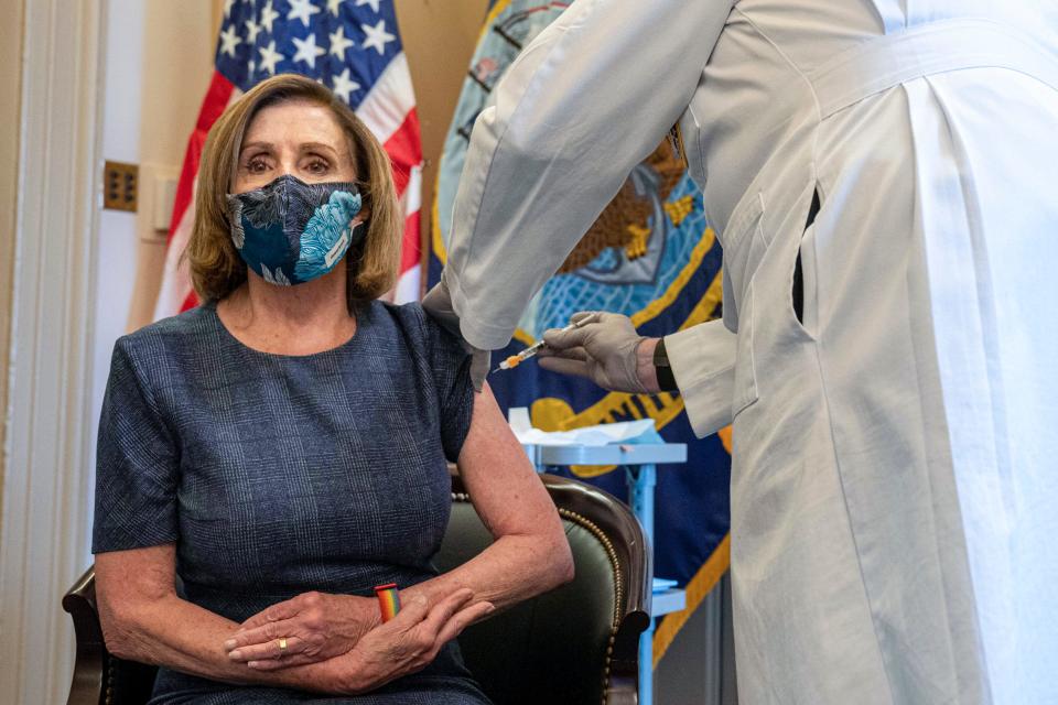 Speaker of the House Nancy Pelosi, D-Calif., receives a Pfizer-BioNTech COVID-19 vaccine shot by Dr. Brian Monahan, attending physician Congress of the United States in Washington on Dec. 18, 2020. The needle is visible in this image; it is not covered by a safety cap.