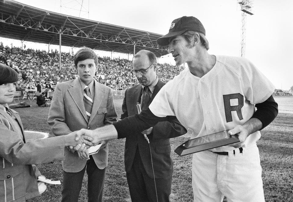 Red Wings shorts stop Bobby Grich hands out an award during pregame ceremonies before the Wings win over Toldeo, 4-1, at Silver Stadium on July 2, 1971.