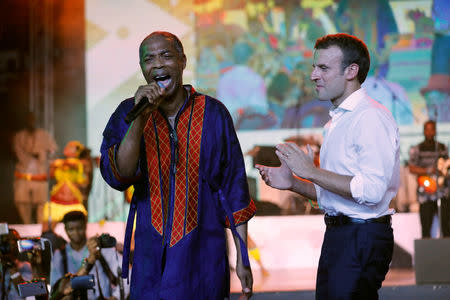 French President Emmanuel Macron (R) stands on stage as Nigerian musician Femi Kuti performs during Macron's visit to the Afrika Shrine nightclub in Nigeria's commercial capital Lagos, July 3, 2018. REUTERS/Akintunde Akinleye
