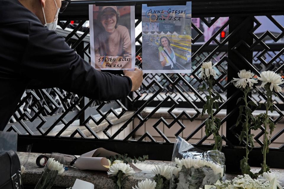 Director Keith Yi (L), acquaintance to some of the Halloween stampede victim's parents, attaches pictures of US victims Steven Blesi and Anne Gieski at the scene of the stampede in Seoul, South Korea, 31 October 2022. According to the National Fire Agency, at least 154 people were killed and 149 were injured in the stampede on 29 October as a large crowd came to celebrate Halloween. Aftermath of Halloween stampede in Seoul, Korea - 31 Oct 2022