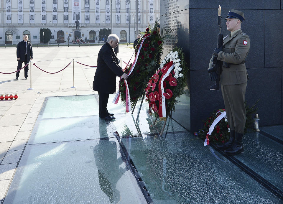 The head of Poland's ruling conservative party, Jaroslaw Kaczynski, during a scaled-down observance in memory of his twin brother, the late President Lech Kaczynski, and 95 other prominent Poles who were killed in a plane crash in Russia 10 years ago, at the monument to the victims in Warsaw, Poland, on Friday, April 10, 2020. The observances were scaled down to just a few people and no crowd under social distancing regulations against the spread of the coronavirus. The new coronavirus causes mild or moderate symptoms for most people, but for some, especially older adults and people with existing health problems, it can cause more severe illness or death.(AP Photo/Czarek Sokolowski)