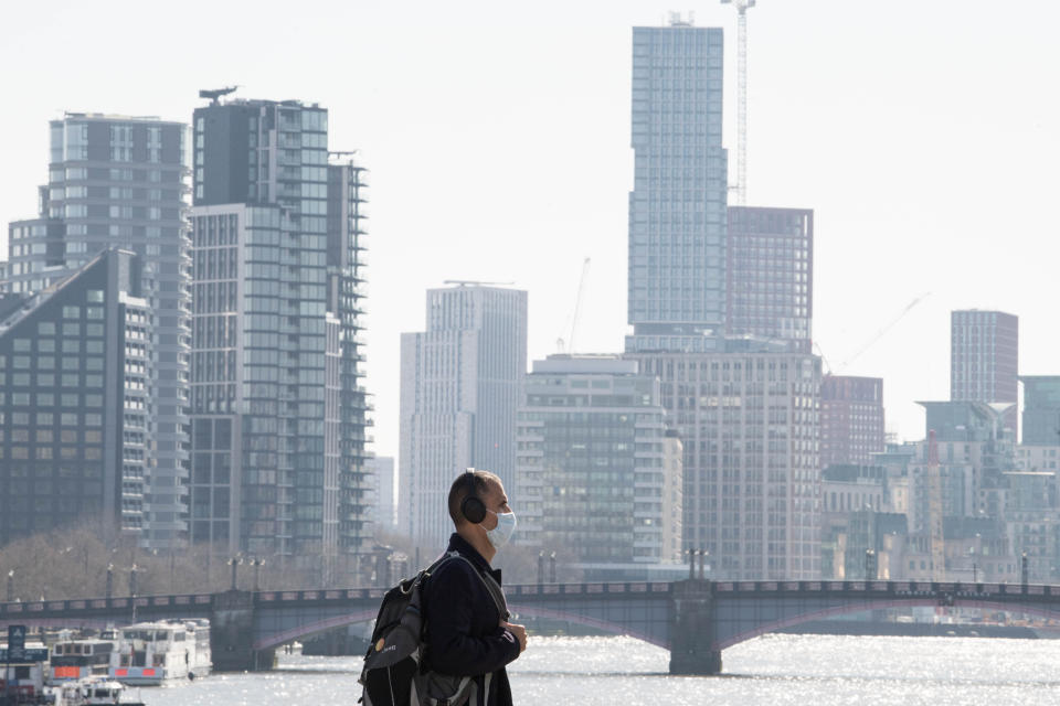 A man wearing a face mask in London, the day after Prime Minister Boris Johnson put the UK in lockdown to help curb the spread of the coronavirus.