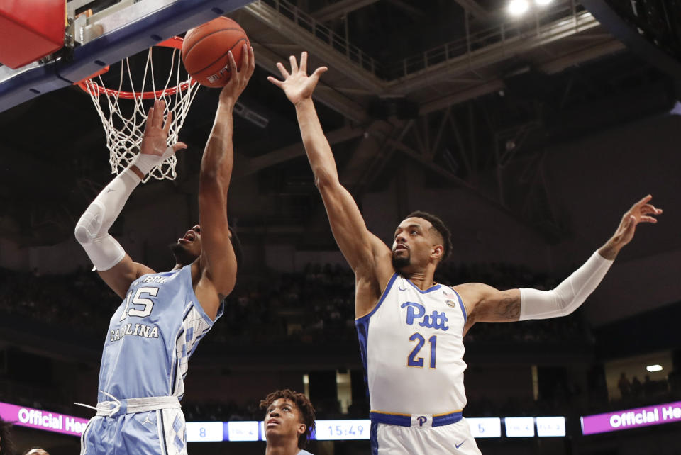 North Carolina's Garrison Brooks (15) shoots as Pittsburgh's Terrell Brown (21) defends during the first half of an NCAA college basketball game, Saturday, Jan. 18, 2020, in Pittsburgh. (AP Photo/Keith Srakocic)