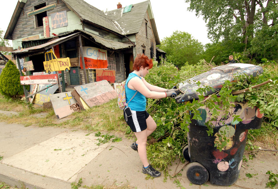 DETROIT, MI - JUNE 16: A volunteer helps clean up abandoned homes as part of the Foster the People, Foster the Future: Do Good Project at Heidelberg Project on June 16, 2012 in Detroit, Michigan. (Photo by Paul Warner/Getty Images)