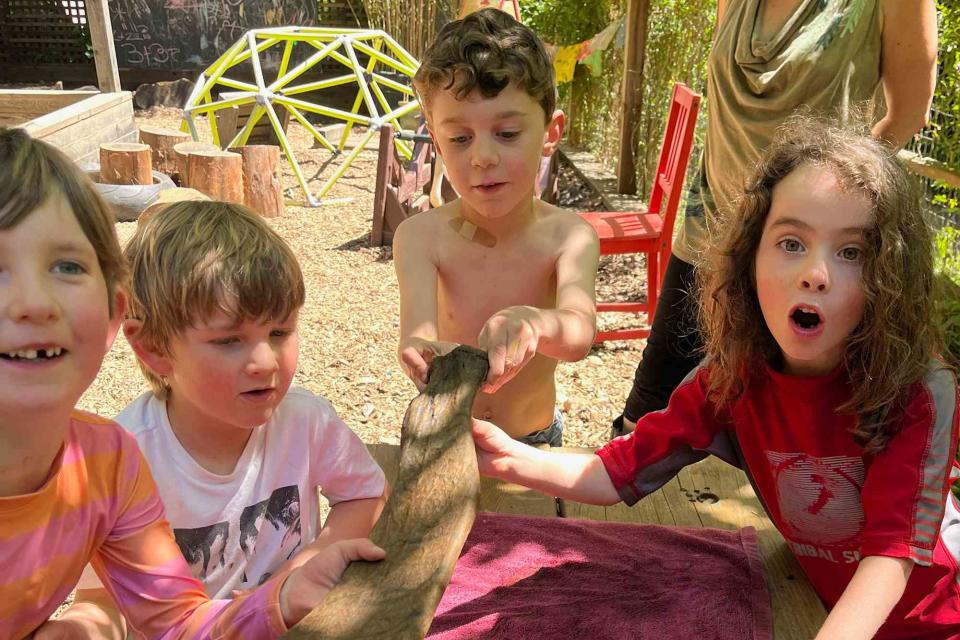 <p>Tara Redwood School</p> Elementary school students display their found Sloth bone