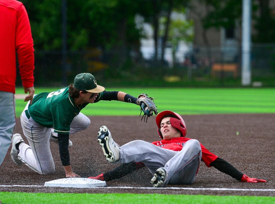 Durfee’s Owen Moniz slides safely past Lynn Classical’s Christian Figueroa during last season’s playoff game against Lynn Classical.