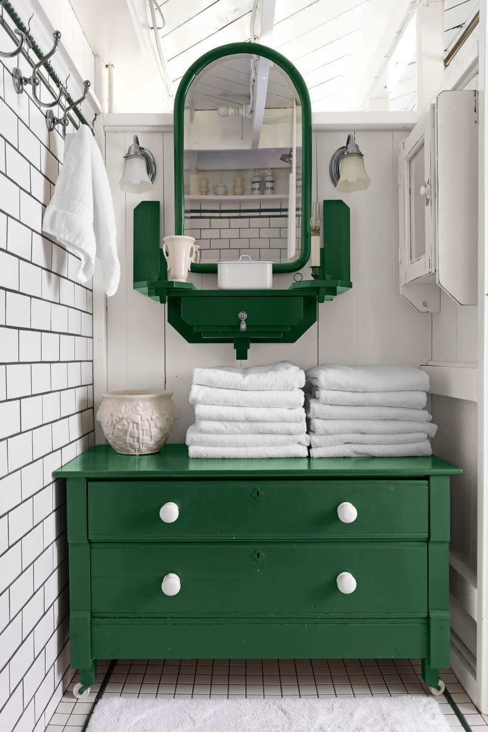 white bathroom with green dresser