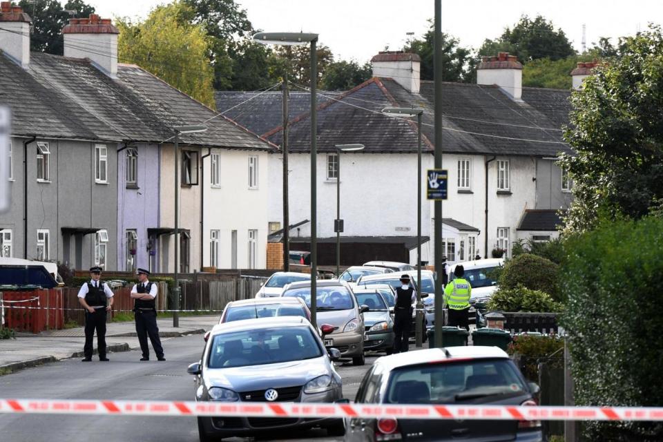 Police: Officers guarding a 100m cordon that has been erected around the residential address in Surrey (AFP/Getty Images)