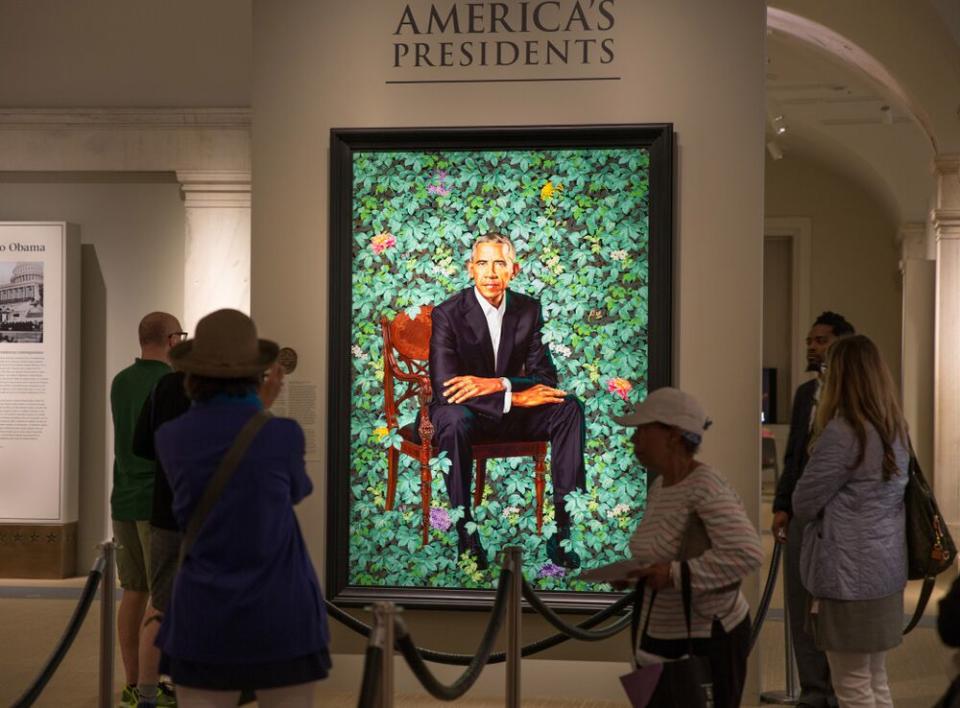 Visitors looking at Kehinde Wiley's portrait of President Barack Obama in June 2018. | George Rose/Getty Images