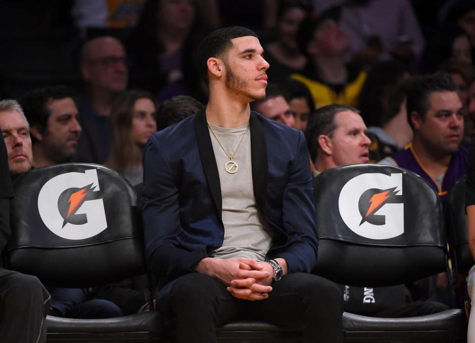 Los Angeles Lakers point guard Lonzo Ball tries to get comfortable on the bench. (Getty Images)