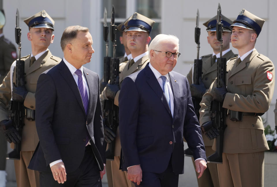 Germany's President Frank-Walter Steinmeier, front right, and his Polish host, President Andrzej Duda, front left, walk during a welcoming ceremony at the Presidential Palace in Warsaw, Poland, Thursday, June 17, 2021 at the start of Steinmeier's brief visit marking 30 years of bilateral good-neighborly relations treaty. Their talks are expected to include the future of the European Union and its tran-Atlantic ties, the developments in Ukraine and Belarus and the divisive Nord Stream 2 gas pipeline between Russia and Germany. (AP Photo/Czarek Sokolowski)