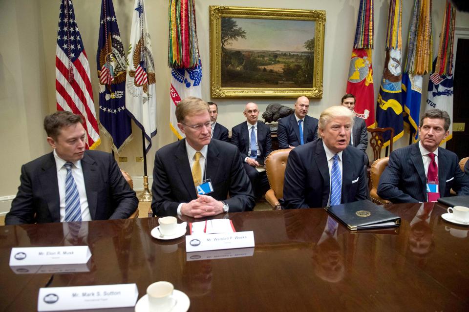 US President Donald Trump meets with business leaders in the Roosevelt Room at the White House in Washington, DC, on January 23, 2017. 
From L to R, SpaceX CEO Elon Musk, Corning CEO Wendell Weeks, Trump and Johnson & Johnson CEO Alex Gorsky. / AFP / NICHOLAS KAMM        (Photo credit should read NICHOLAS KAMM/AFP via Getty Images)