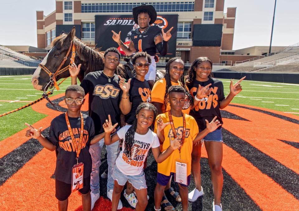 Rodney Fields Jr. (on horseback) gathers with his family during his recruiting visit to Oklahoma State. After the Cowboys extended an offer, Fields shut down his recruitment because he knew he wanted to continue his career in Stillwater.