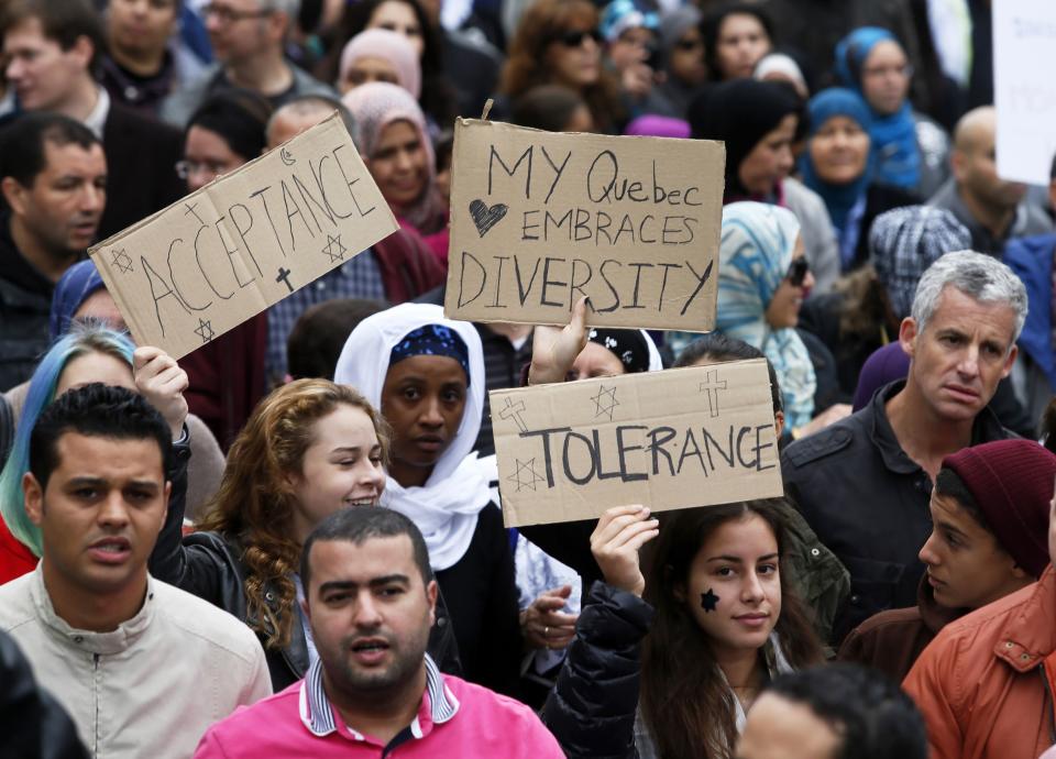 Demonstrators hold signs as they protest against Quebec's proposed Charter of Values in Montreal