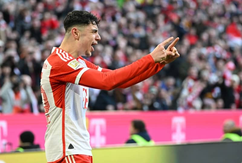 Munich's Aleksandar Pavlovic celebrates scoring his side's first goal during the German Bundesliga soccer match between Bayern Munich and Borussia Moenchengladbach at the Allianz Arena. Angelika Warmuth/dpa