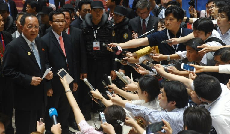 North Korea's Foreign Minister Ri Yong Ho (L) speaks to reporters after attending the Regional Security Forum (ARF) meeting held on the sideline of ASEAN's annual ministerial meeting in Vientiane on July 26, 2016