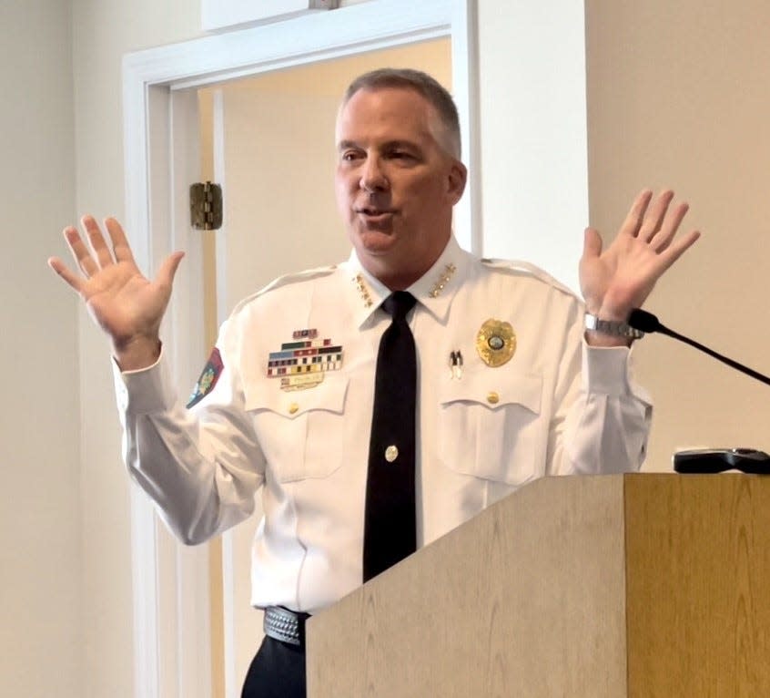 Orange City Police Chief Peter Thomas talks to audience and council member at city hall on Tuesday. After 30 years as a policeman, 11 of which he was chief, Thomas officially retires on Friday.