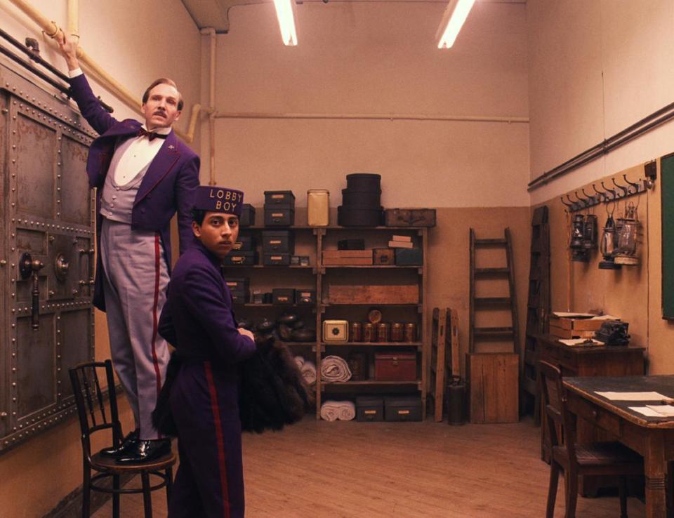 This image released by Fox Searchlight shows Ralph Fiennes, left, and Tony Revolori in "The Grand Budapest Hotel. Sandwiched between the swaggering spectacle of summer and the chest-thumping ambition of awards season, spring moviegoing is usually an afterthought, a limbo for films not bankable enough for July or sufficiently arty-seeming for Oscar. But this season, the movies are alive. (AP Photo/Fox Searchlight)