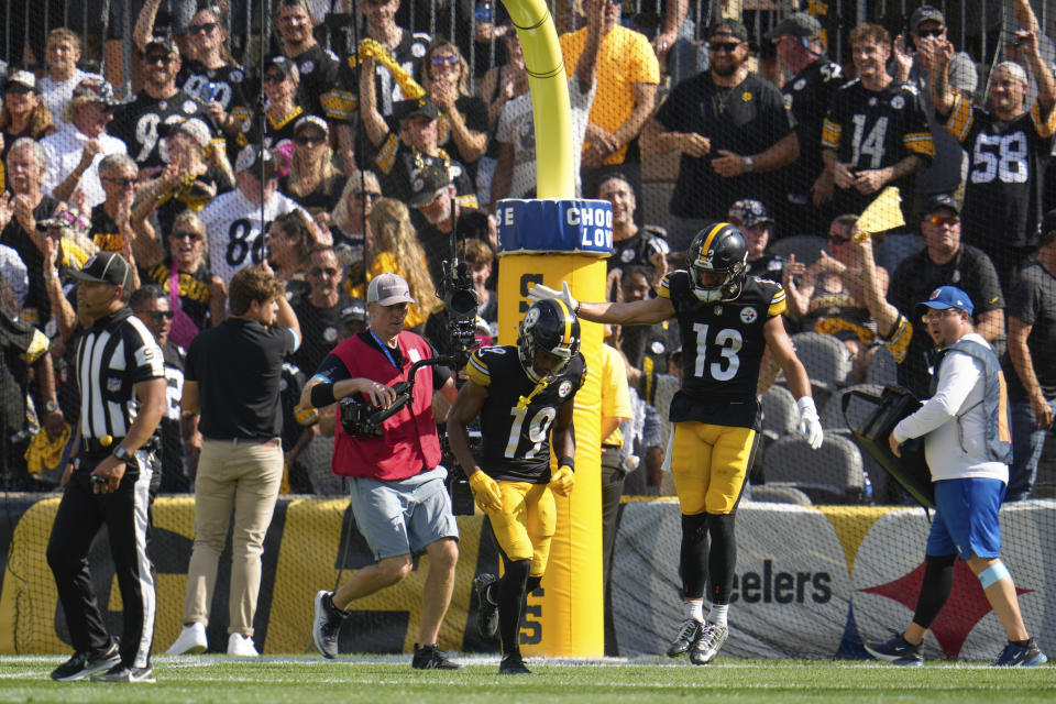 Pittsburgh Steelers wide receiver Calvin Austin III (19) is congratulated by Scotty Miller (13) after scoring a touchdown during the second half of an NFL football game against the Los Angeles Chargers, Sunday, Sept. 22, 2024, in Pittsburgh. (AP Photo/Gene J. Puskar)