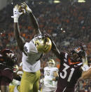 Notre Dame wide receiver Kevin Austin Jr. (4) catches a two-point conversion pass in front of Virginia Tech defensive back Nasir Peoples (31) during the second half of an NCAA college football game in Blacksburg, Va., Saturday, Oct. 9, 2021. (AP Photo/Matt Gentry)