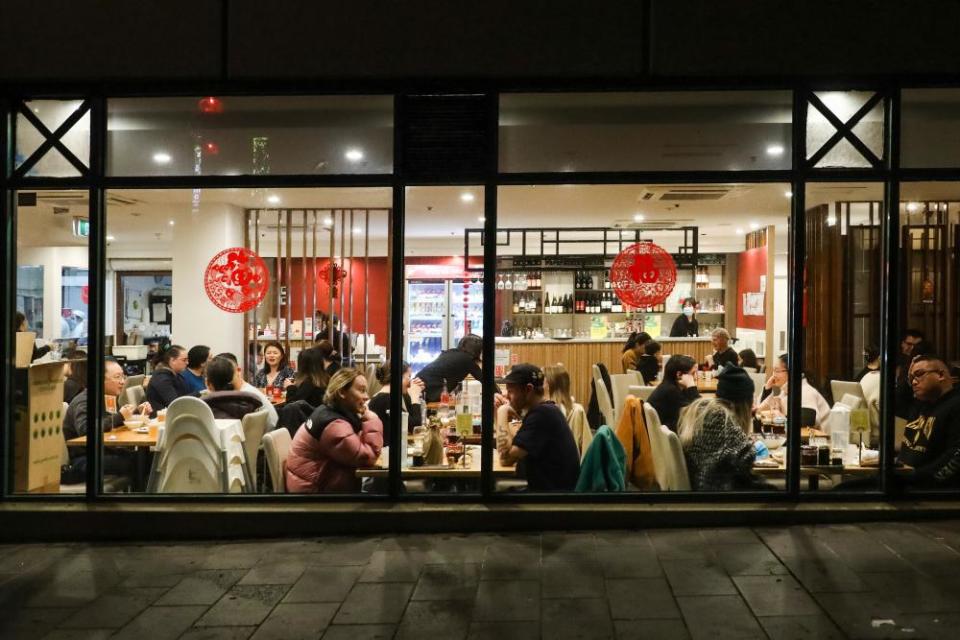 Diners sit at tables inside a restaurant in China Town in Melbourne.