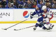 New York Rangers defenseman K'Andre Miller (79) checks Tampa Bay Lightning left wing Boris Katchouk (13) as he carries the puck during the second period of an NHL hockey game Friday, Dec. 31, 2021, in Tampa, Fla. (AP Photo/Chris O'Meara)