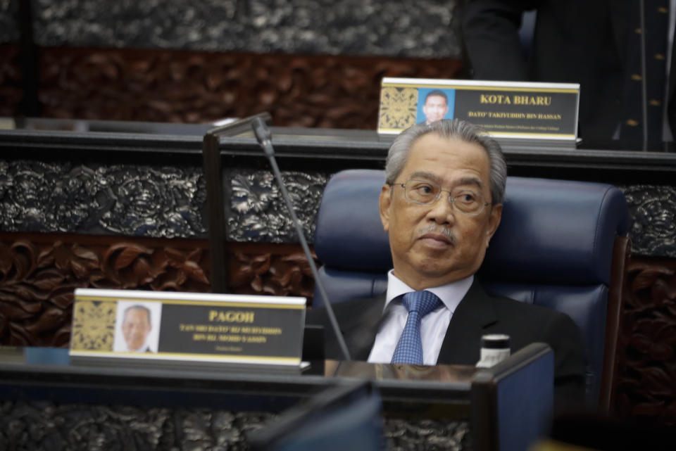 Prime Minister Muhyiddin Yassin attending parliament session at parliament lower house in Kuala Lumpur, Malaysia, Monday, July 13, 2020. (AP Photo/Vincent Thian)