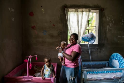 Rose Boncoeur, shown posing with her two foster children at her modest home, is among 120 householders who have opened their doors to children with nowhere else to go