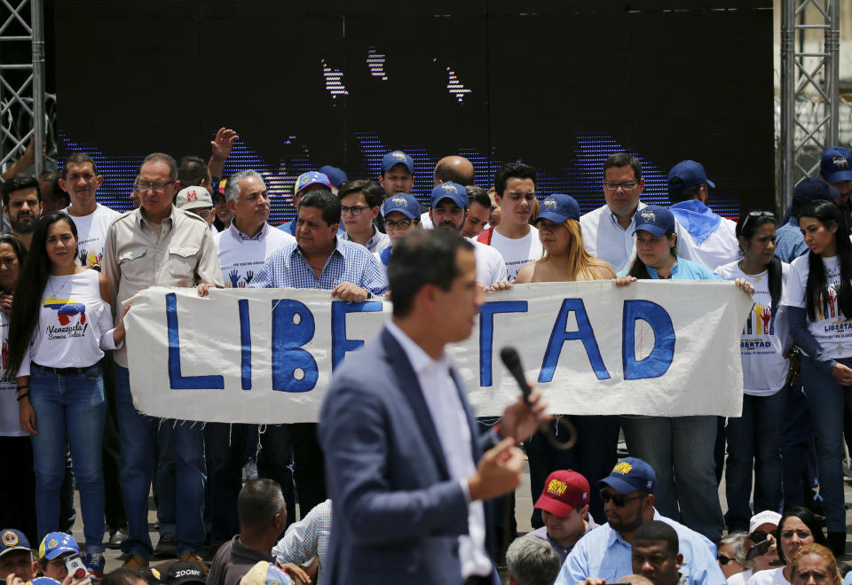 Members of Venezuelan National Assembly holds a sign that reads in Spanish "Freedom" as opposition leader and self proclaimed president Juan Guaido, delivers a speech during a rally in Caracas, Venezuela, Saturday, April 27, 2019. The Trump administration has added Venezuelan Foreign Minister Jorge Arreaza to a Treasury Department sanctions target list as it increases pressure on Guaido's opponent, embattled President Nicolas Maduro. (AP Photo/Fernando Llano)