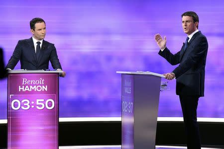 French Socialist party politicians, former prime minister Manuel Valls (R) and former education minister Benoit Hamon attend the final debate in the French left's presidential primary election in La Plaine-Saint-Denis, near Paris, France, January 25, 2017. REUTERS/Bertrand Guay/Pool