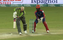 Qalandars batsman Ben Dunk, left, plays a shot while Karachi Kings wicketkeeper Chadwick Walton watches during the final of Pakistan Super League T20 cricket match at National Stadium in Karachi, Pakistan, Tuesday, Nov. 17, 2020. (AP Photo/Fareed Khan)