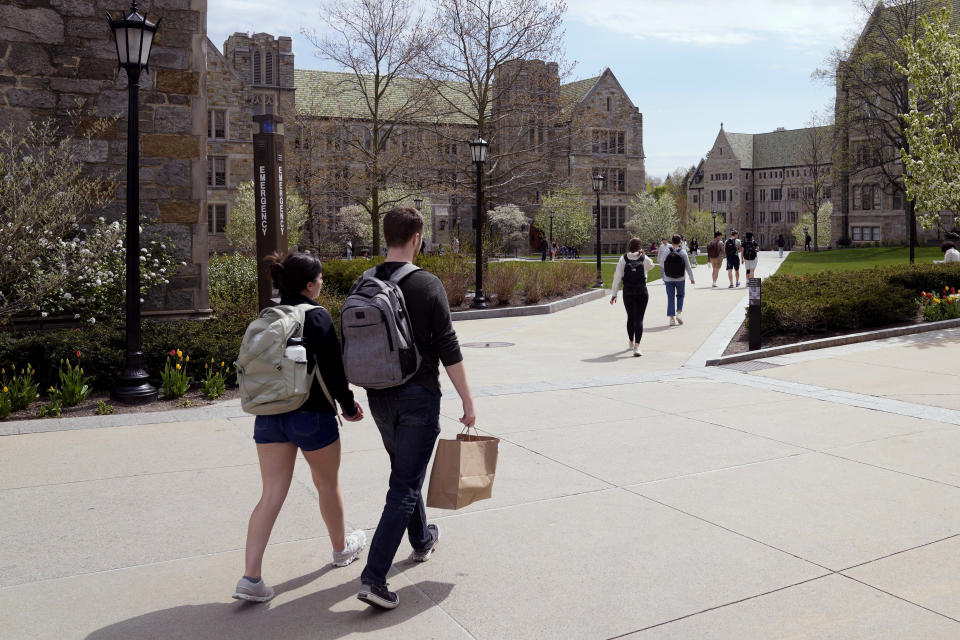 Students walk on the campus of Boston College, Monday, April 29, 2024, in Boston. While many colleges and universities in the Boston area have been scenes of encampments and arrests, Boston College has been relatively quiet. (AP Photo/Charles Krupa)