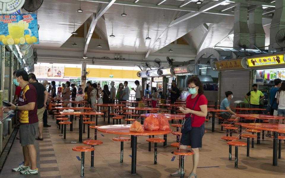 Queues for takeaways have returned to Singapore after its ban on indoor dining - Wei Leng Tay/Bloomberg
