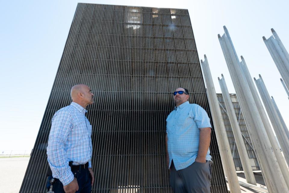 Trent Schaffer and Javier Miranda stand in front of a spare metal louver.