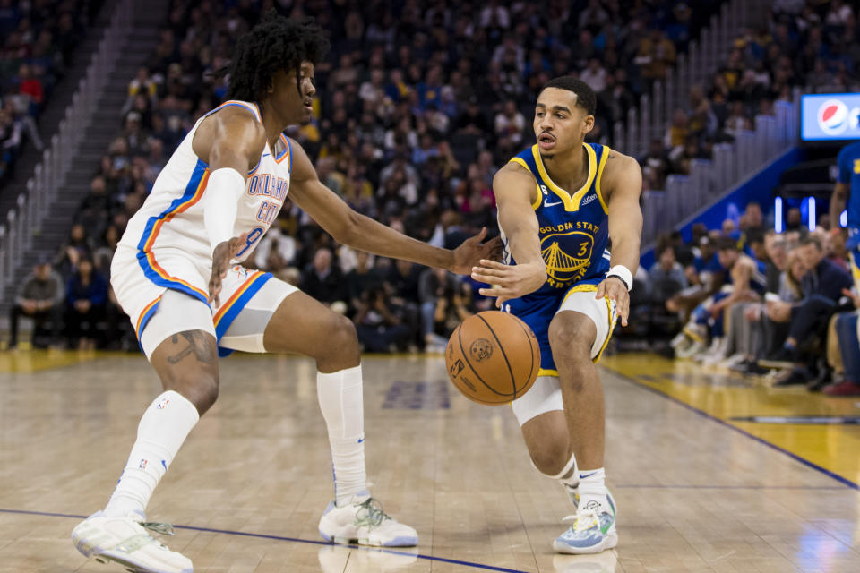 Golden State Warriors guard Jordan Poole (3) passes the ball past Oklahoma City Thunder forward Jalen Williams (8) during the first half of an NBA basketball game in San Francisco, Monday, Feb. 6, 2023. (AP Photo/John Hefti)