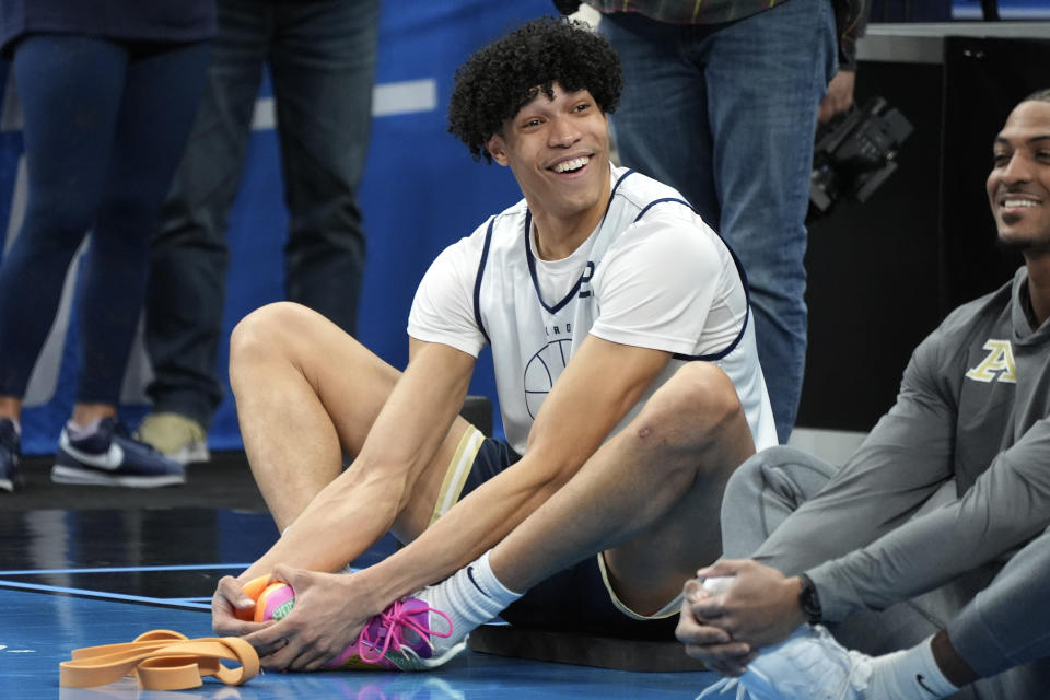 Akron's Enrique Freeman, center, stretches during the NCAA college men's basketball team practice at PPG Paints Arena in Pittsburgh, Wednesday, March 20, 2024. Akron will face Creighton in a first round tournament game on Friday. (AP Photo/Gene J. Puskar)