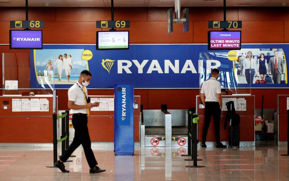 A man stands at a Ryanair check-in desk at Josep Tarradellas Barcelona-El Prat airport -  ALBERT GEA/ REUTERS