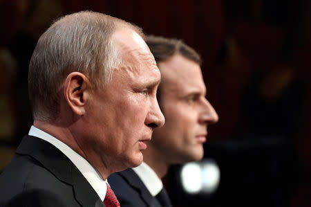 French President Emmanuel Macron (R) and Russian President Vladimir Putin (L) give a joint press conference at the Chateau de Versailles before the opening of an exhibition marking 300 years of diplomatic ties between the two countries in Versailles, France, May 29, 2017. REUTERS/Stephane De Sakutin/Pool