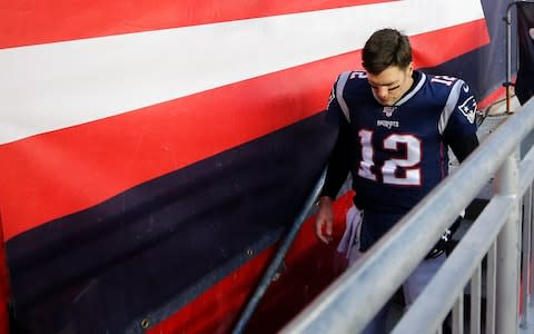 New England Patriots quarterback Tom Brady (12) leaves the field after their loss to the Miami Dolphins at Gillette Stadium - Credit: USA Today