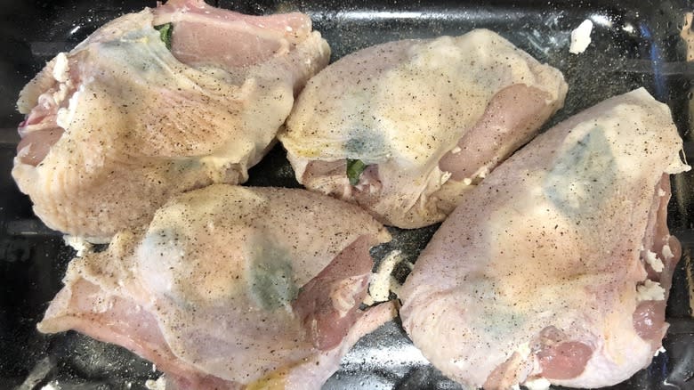 Raw chicken in baking tray