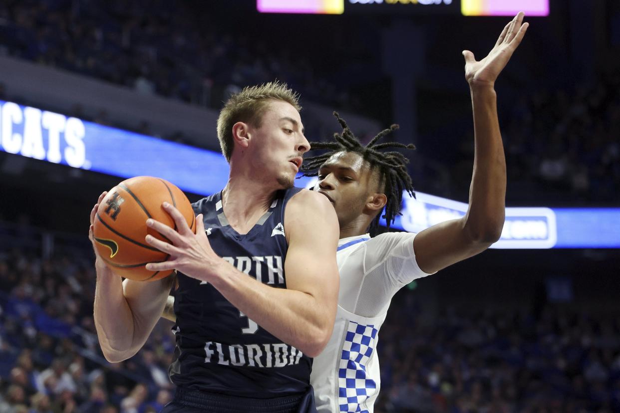 UNF's Carter Hendricksen (3) pulls down a rebound against Kentucky's Damion Collins (4) last Friday at Rupp Arena in Lexington, Ky.