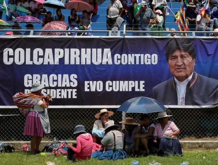 Supporters of Bolivia's President Evo Morales rest during a Democratic and Cultural revolution celebration at a stadium in Ivirgarzama in the Chapare region, Bolivia December 18, 2016. The banner reads, "Colcapirhua is with you, Thanks President Evo". REUTERS/David Mercado