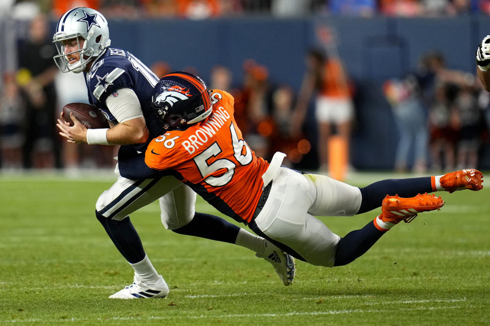 Denver Broncos linebacker Baron Browning (56) tackles Dallas Cowboys quarterback Cooper Rush (10) during the first half of an NFL preseason football game, Saturday, Aug. 13, 2022, in Denver. (AP Photo/Jack Dempsey)