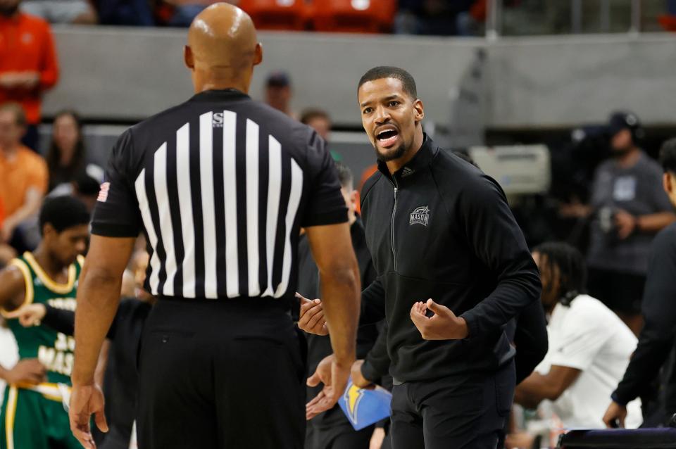 George Mason Patriots head coach Kim English talks to an official during the first half against the Auburn Tiger on Nov. 7. On Thursday, English was officially named the Providence College coach.