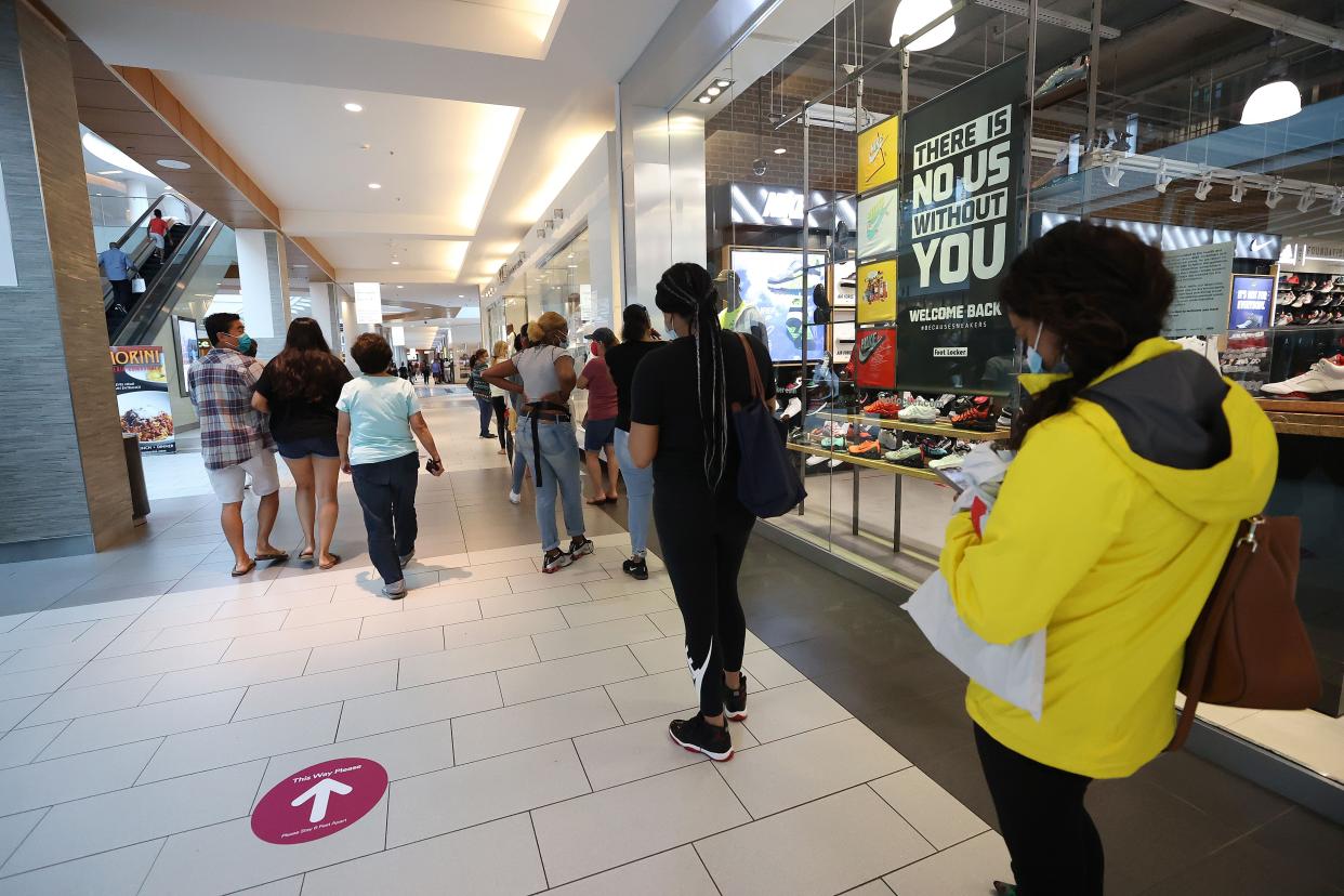 Customers wait to enter JD sneaker store at Roosevelt Field Mall on July 10, 2020 in Garden City, New York.