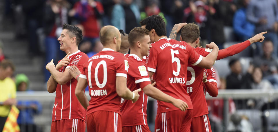 Munich’s Robert Lewandowski, left, celebrates his goal together with his team (Andreas Gebert/dpa via AP)