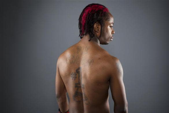 Boxer Rau'shee Warren stretches while posing for a portrait during the 2012 U.S. Olympic Team Media Summit in Dallas, May 15, 2012.