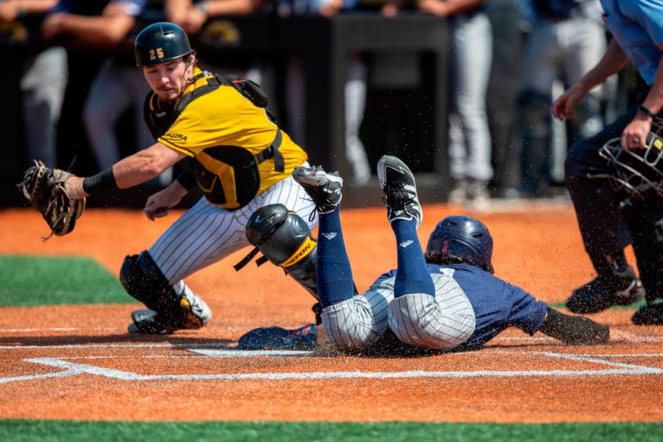 Southern Miss catcher Blake Johnson catches the ball as a UTSA player safely slides into home during a game against UTSA during the Conference USA tournament at Pete Taylor Park in Hattiesburg on Saturday, May 28, 2022.