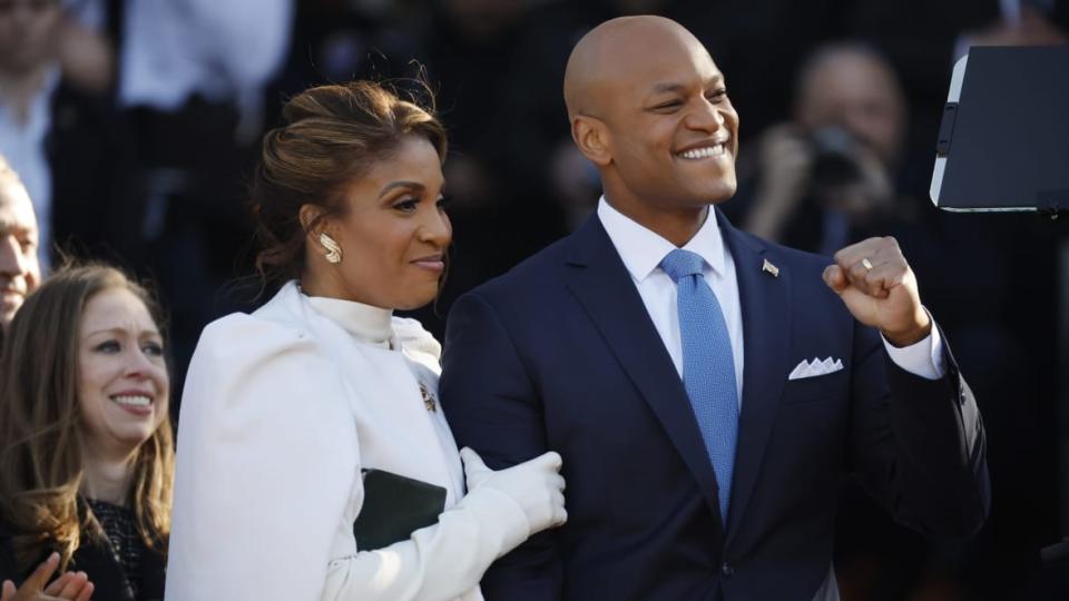 Maryland Governor Wes Moore pumps his fist as he, first lady Dawn Moore (C) and Chelsea Clinton attend his inauguration ceremony at the Maryland State House on January 18, 2023 in Annapolis, Maryland. Moore was sworn in on a bible that once belonged to former slave and abolitionist Frederick Douglass. Democrat Moore defeated Republican nominee Dan Cox to become the first Black governor of Maryland and only the third Black person to be elected governor in the United States. (Photo by Chip Somodevilla/Getty Images)